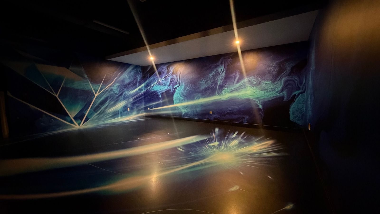 Dyer Design Glassworks immersive studio in the Thrive District, Fort Lauderdale, with custom-wrapped illuminated glass walls and floor